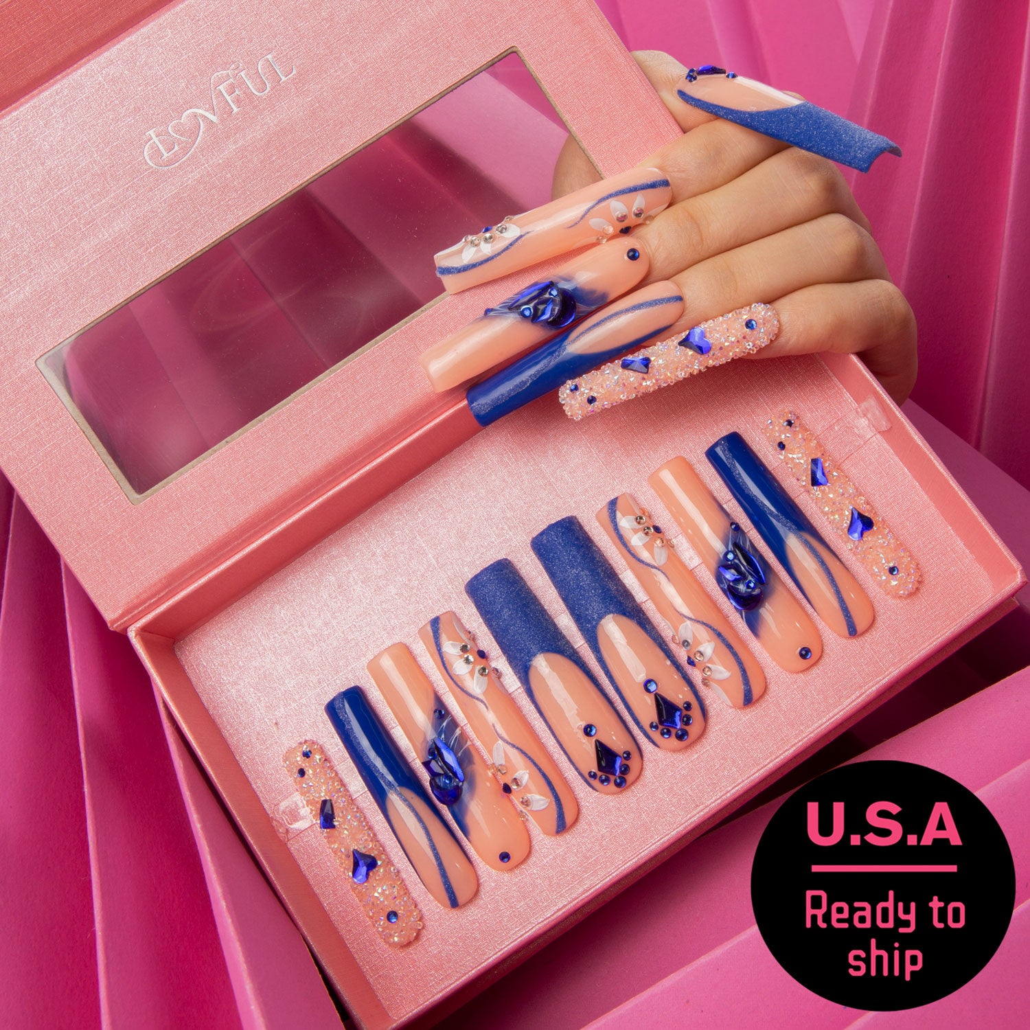 Set of 'Blue Suede' press-on nails by Lovful, featuring blue French tips with curvy lines, crystal decorations, and blue heart-shaped gems, ready to ship in the U.S.A.