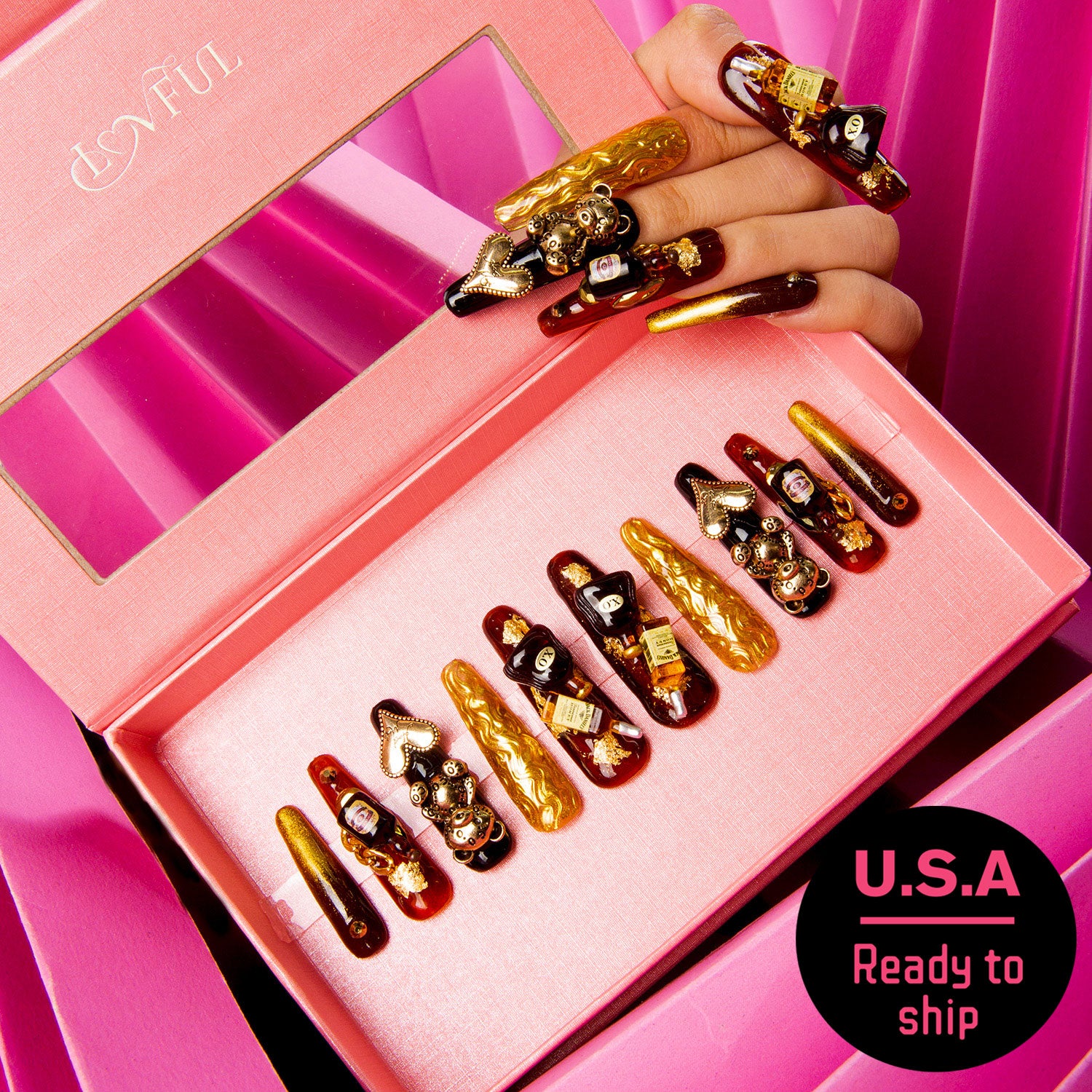 Luxurious 'Casino Party' press-on nails in a pink box, featuring black and gold designs with bear and heart-shaped gems, and wine bottle charms. U.S.A Ready to ship.