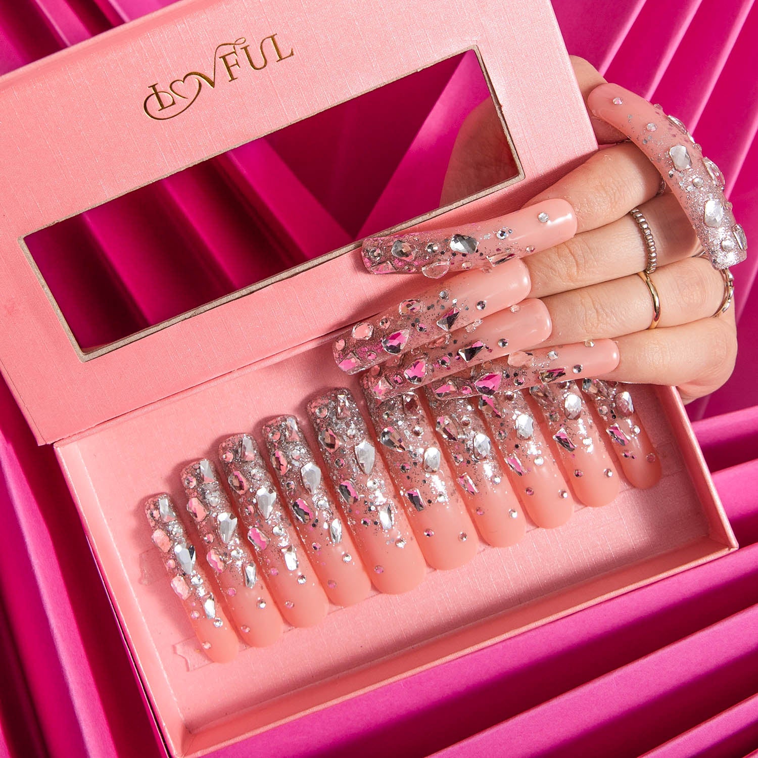 Lovful 'H126 - Silver Wind - Curve' press-on acrylic nails in pink packaging with silver glitter and rhinestone design, model's hand showcasing one nail.