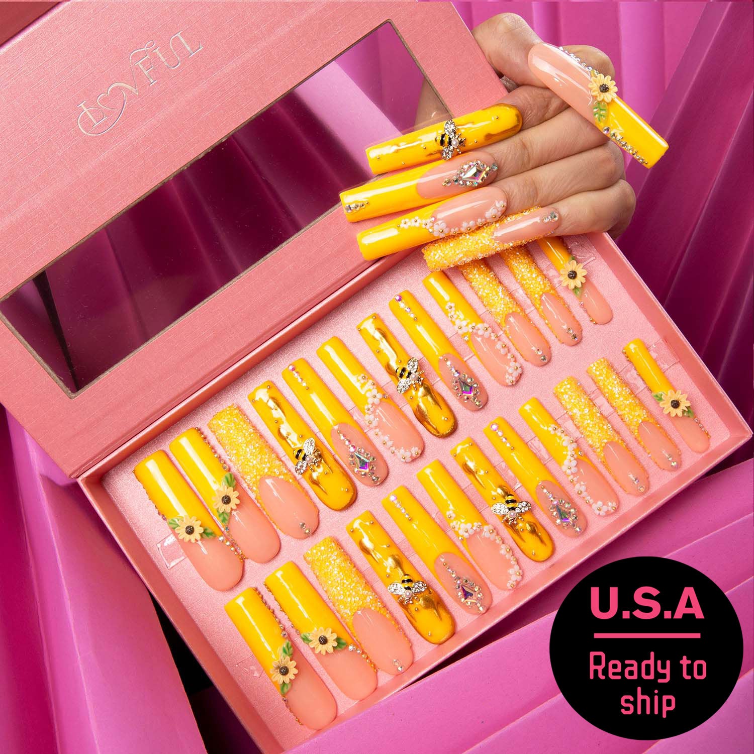 Bright yellow and peach sunflower patterned press-on nails with bee accents in pink box, labeled 'U.S.A Ready to Ship'