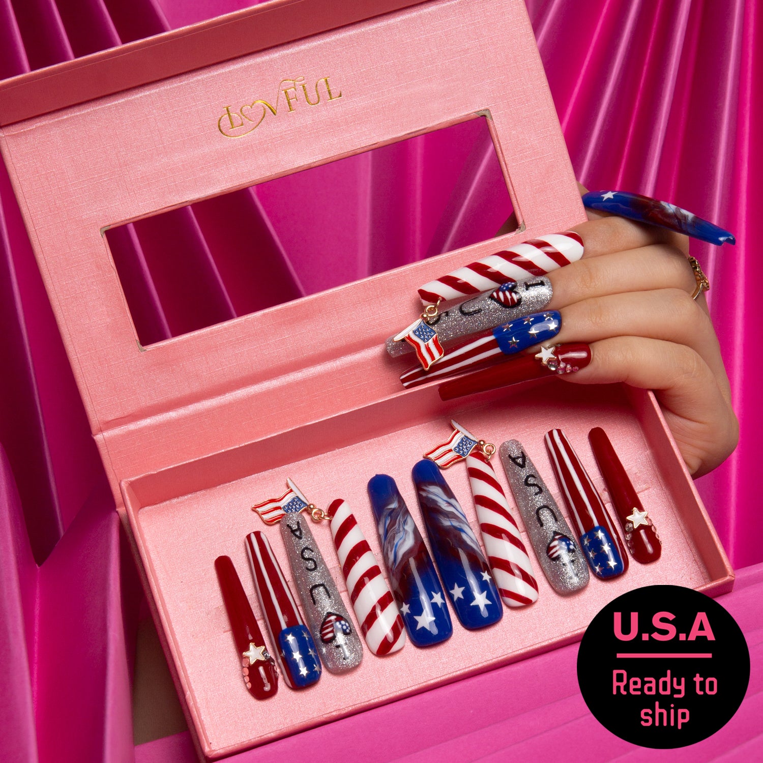 Patriotic 'American Dream' press-on acrylic nails set by Lovful.com featuring red, white, and blue designs in an open pink box. Includes glitter, stars, and American flag accents. Ready to ship for Independence Day celebrations.