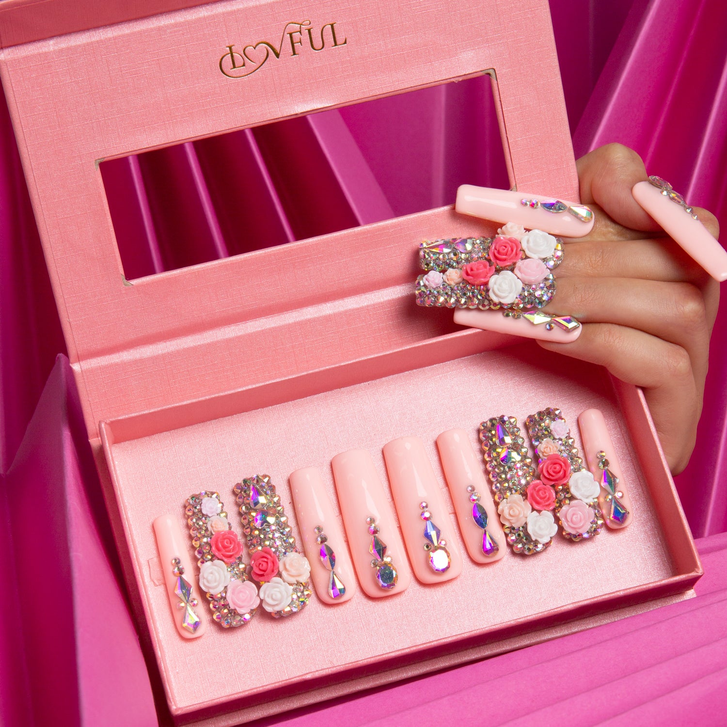 Rose Garden Bliss press-on nails by Lovful, featuring delicate roses and shimmering rhinestones, displayed in an open pink box.