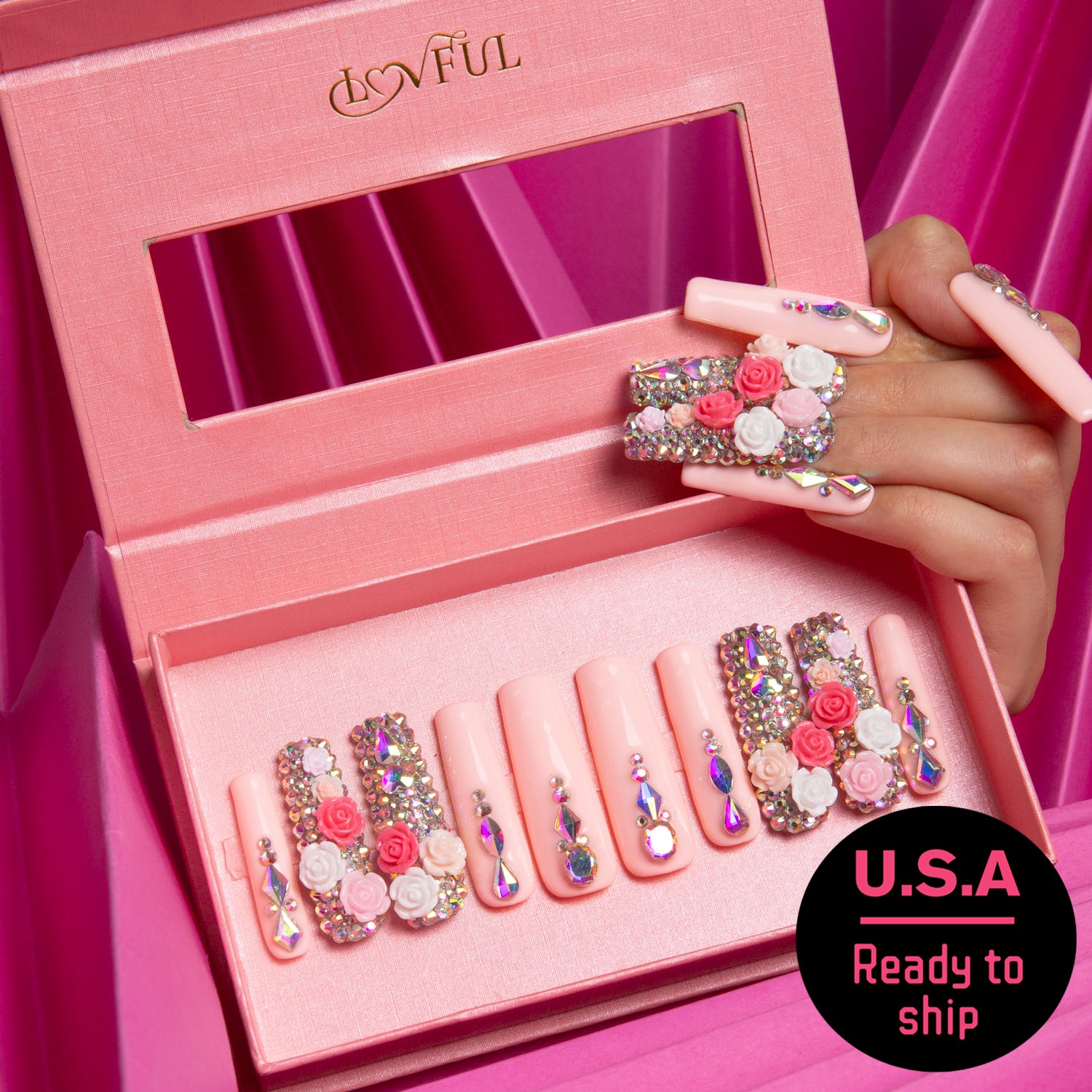 Lovful Rose Garden Bliss press-on nails set displayed in a pink box. Each nail showcases delicate roses and rhinestones on a light pink background. Text on the box lid reads 'Lovful' and a badge says 'U.S.A Ready to ship'.