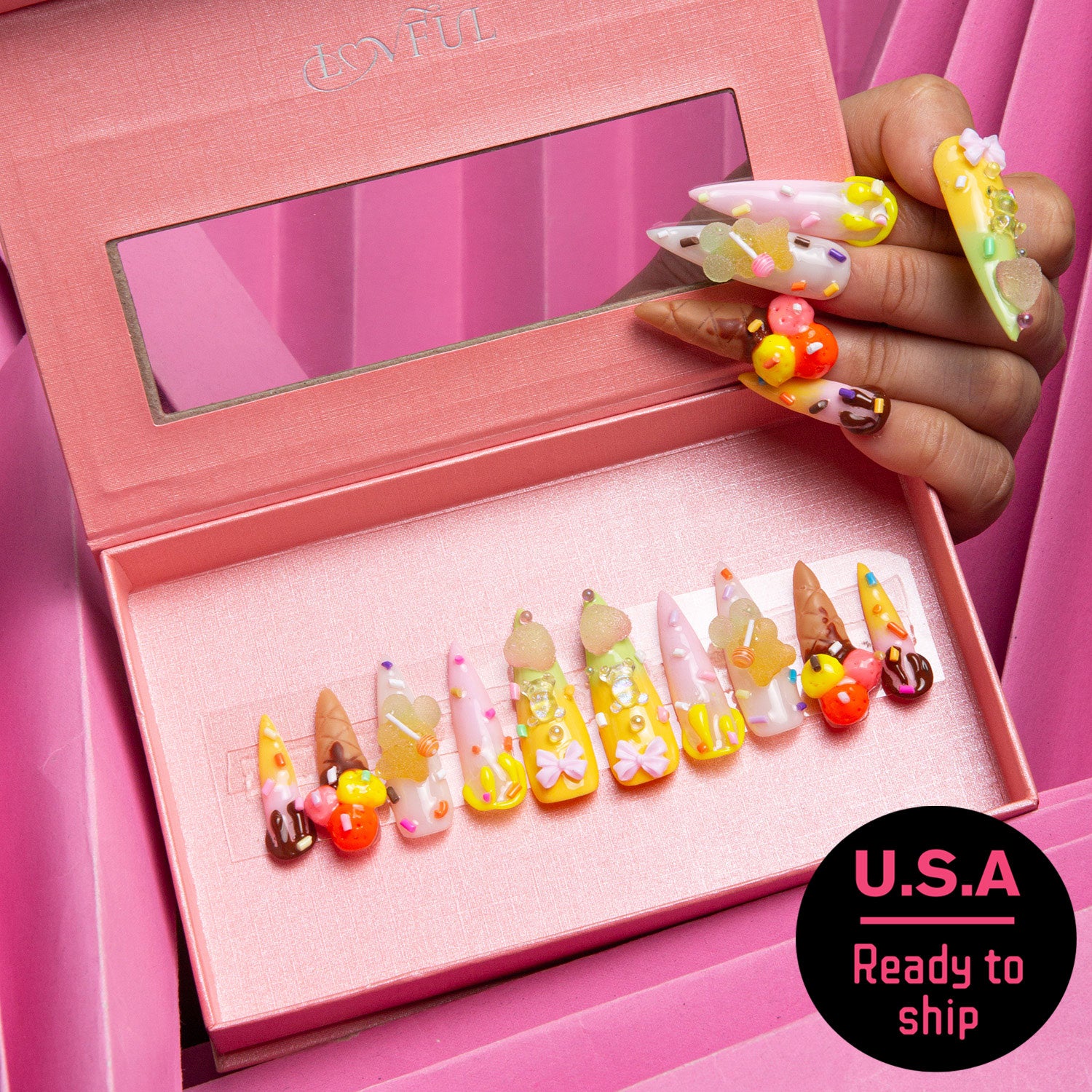 Set of ice cream-themed press-on acrylic nails with 3D decorations of sprinkles, candy canes, and mini ice cream cones, displayed in a pink box with a hand showing similar decorated nails beside it. Text reads 'U.S.A Ready to ship'.