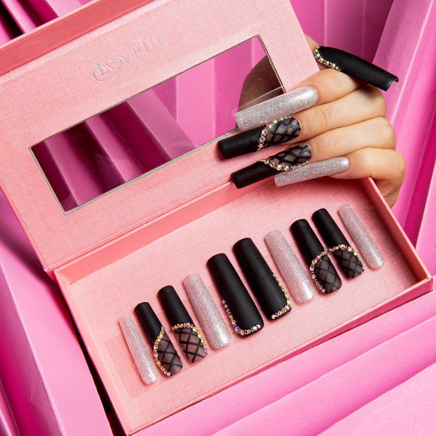 Set of Lovful H114 Black Lace Square press-on nails in a pink box. The nails feature black designs with silver shimmer, lace decor, and rhinestone accents. A hand with matching nails is holding the box.