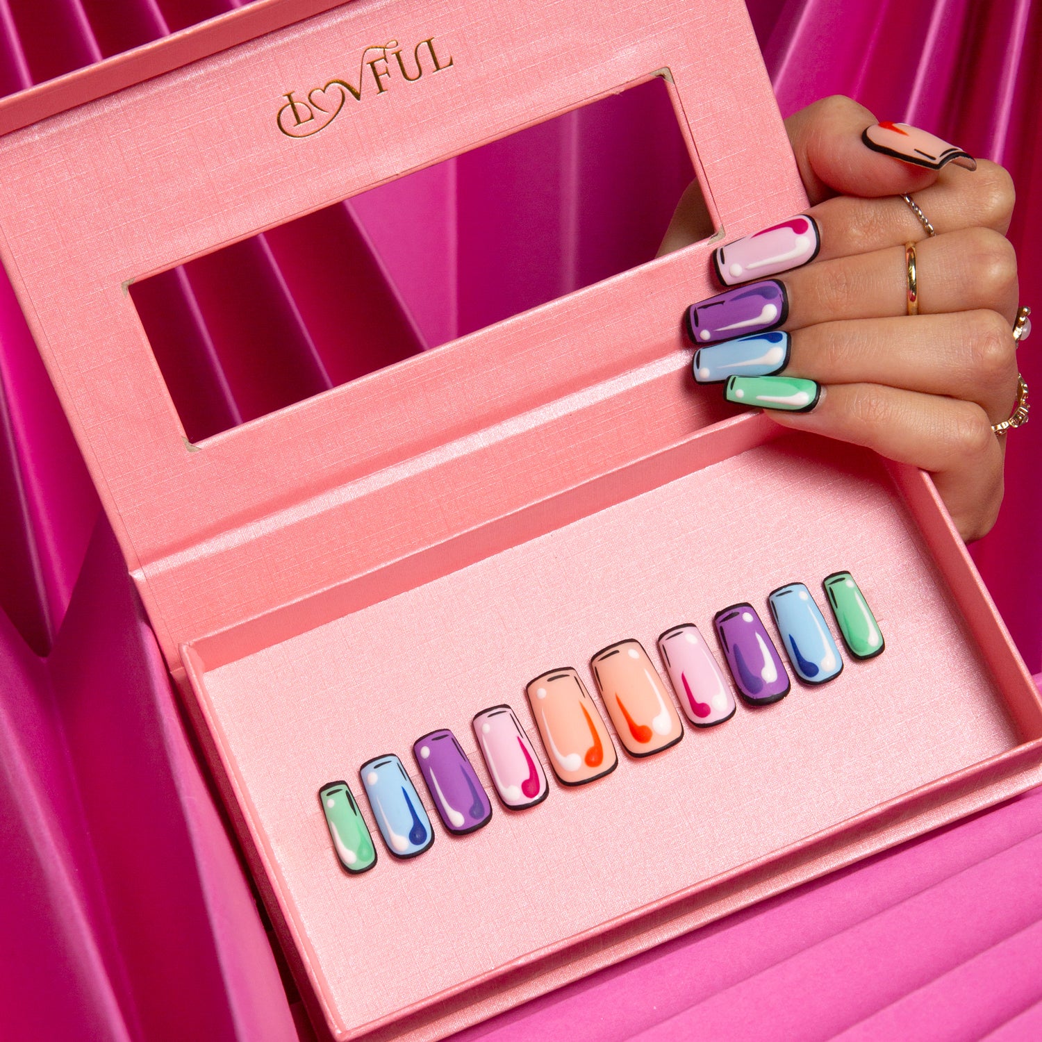 Lovful 'Colorful Pop - Square' press-on nail set featuring vibrant pop art designs in a pink display box, with a hand showing off the colorful nail designs.