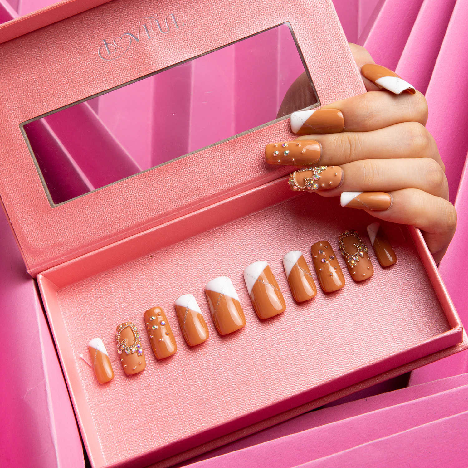 Press-on acrylic nails in a pink box, featuring white French tips with glitter on a nude base. One hand shows the nails applied, highlighting the 'Lovely Kitten Heels' design by Lovful.