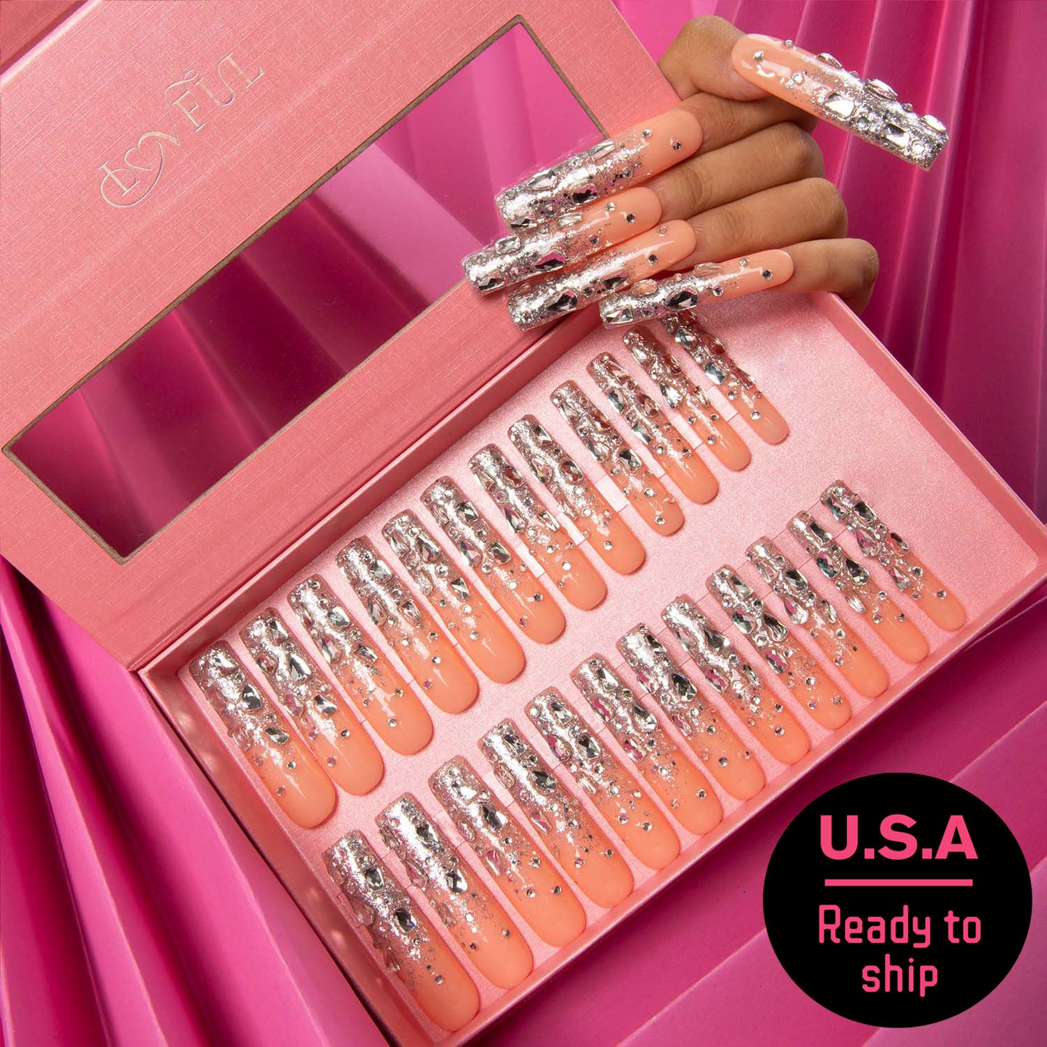 24 pieces of 'Silver Wind' press-on nails in a pink box. The nails feature a peach base with silver glitter and rhinestones. Black and pink sticker in the corner reads 'U.S.A Ready to ship'.