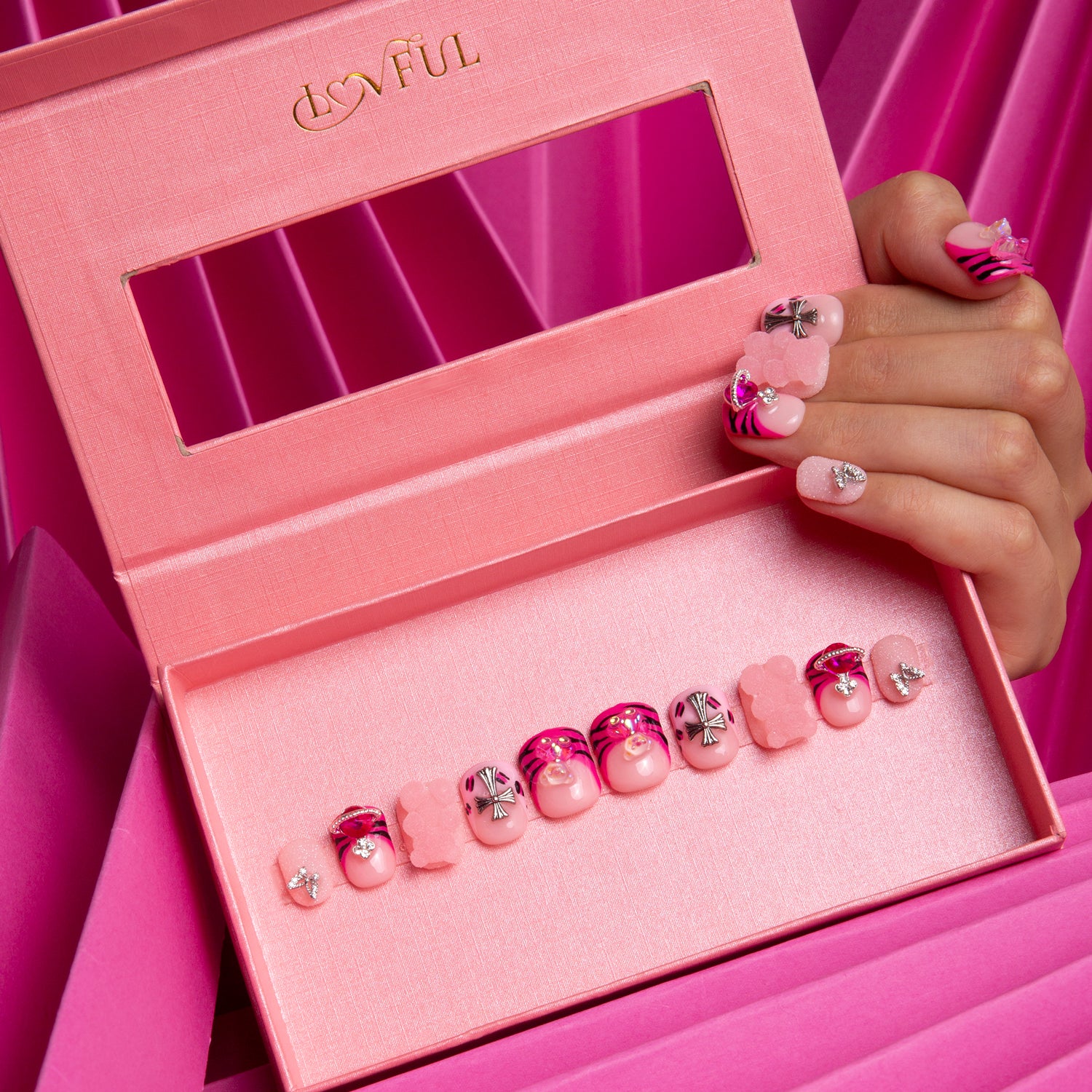Hot pink French tip press-on nails with leopard prints, lips, and butterflies in a pink Lovful box with mirror