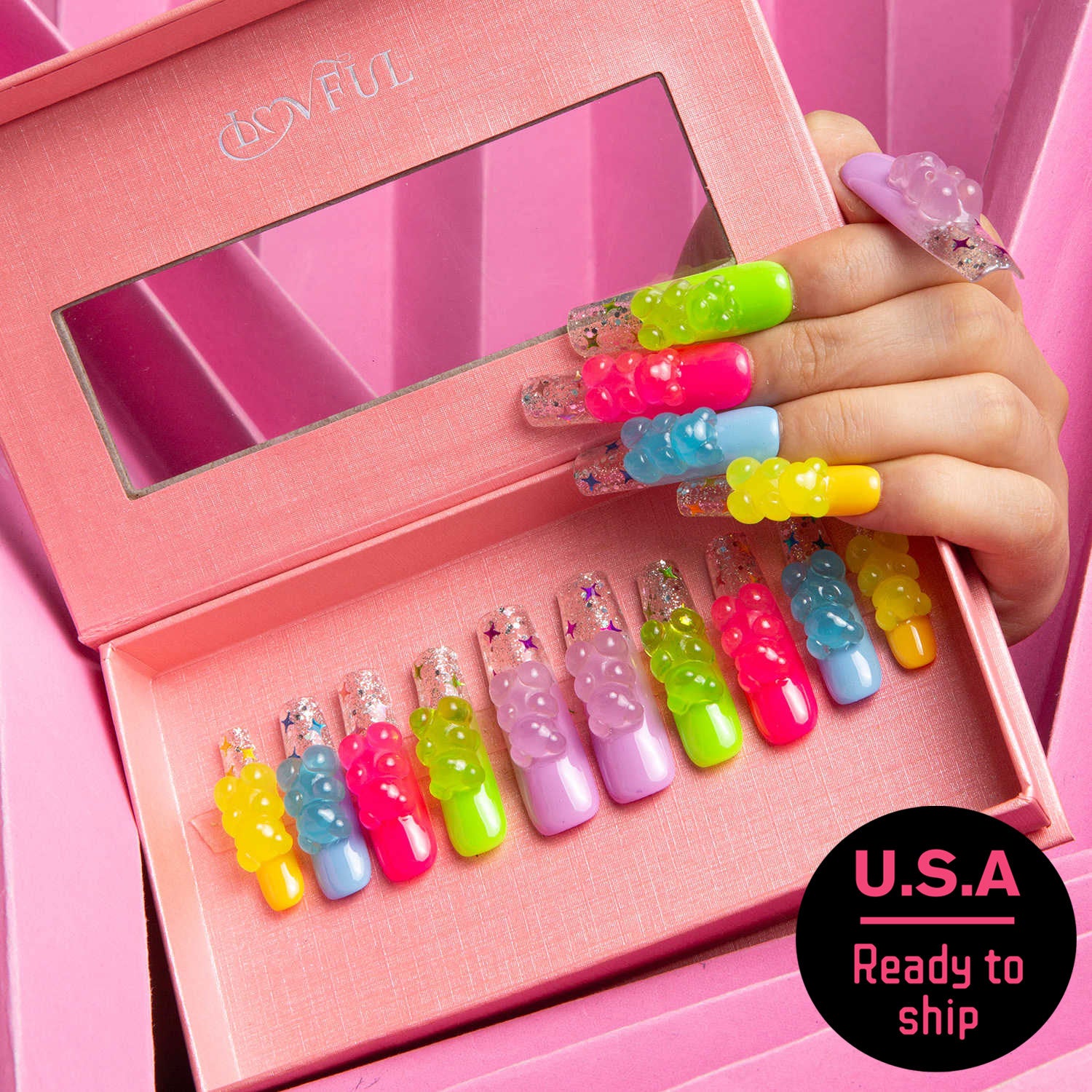 Lovful's 'Sweet Wonderland' press-on nails in a pink box. The vibrant nails are adorned with colorful gummy bear charms and glitter accents, ready to ship in the USA.