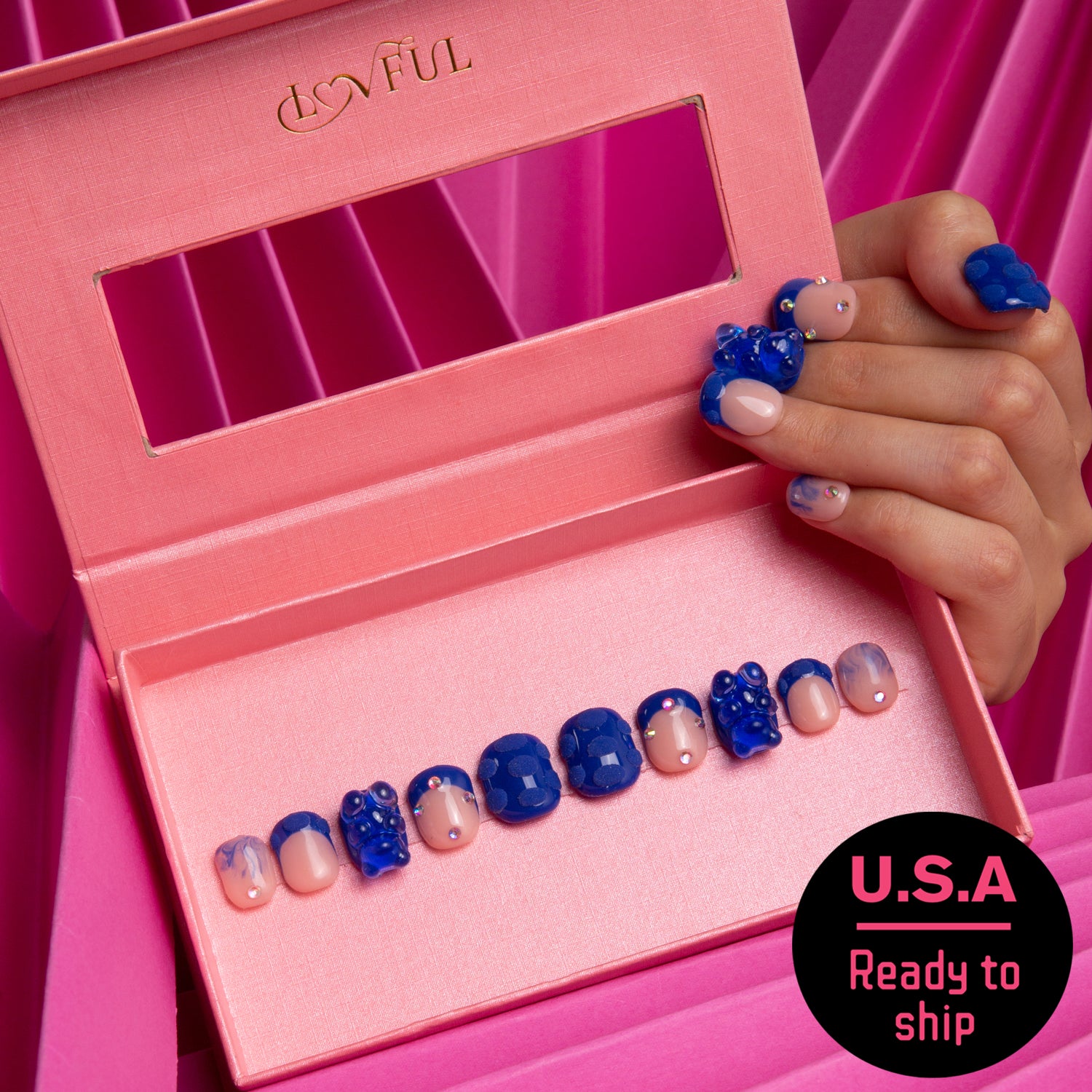 Little Blue Bear Rhinestone French tip press-on nails with blue gummy bears and shiny rhinestones, presented in a pink box. A hand holding the box showcases similar nail design. Includes 'U.S.A Ready to ship'.