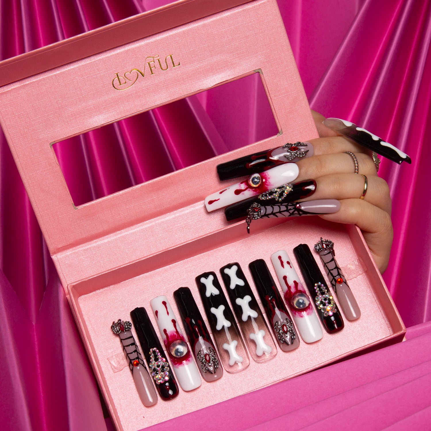 Boxed set of Lovful 'Final Destination' press-on nails with spooky designs including blood drips, bones, eyes, and spider webs, in red, black, and white hues, perfect for Halloween.