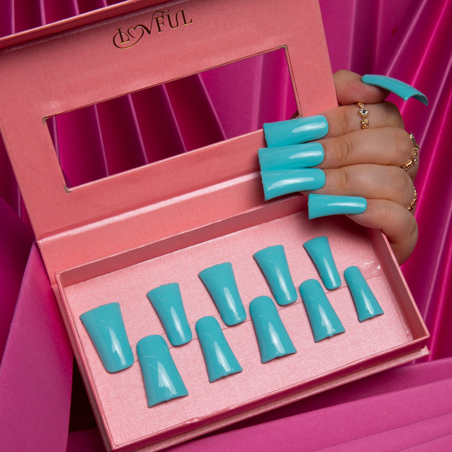 Lovful Shiny Blue press-on acrylic nails in a pink box, featuring a hand with blue nails, perfect for vacation vibes and seaside getaways.