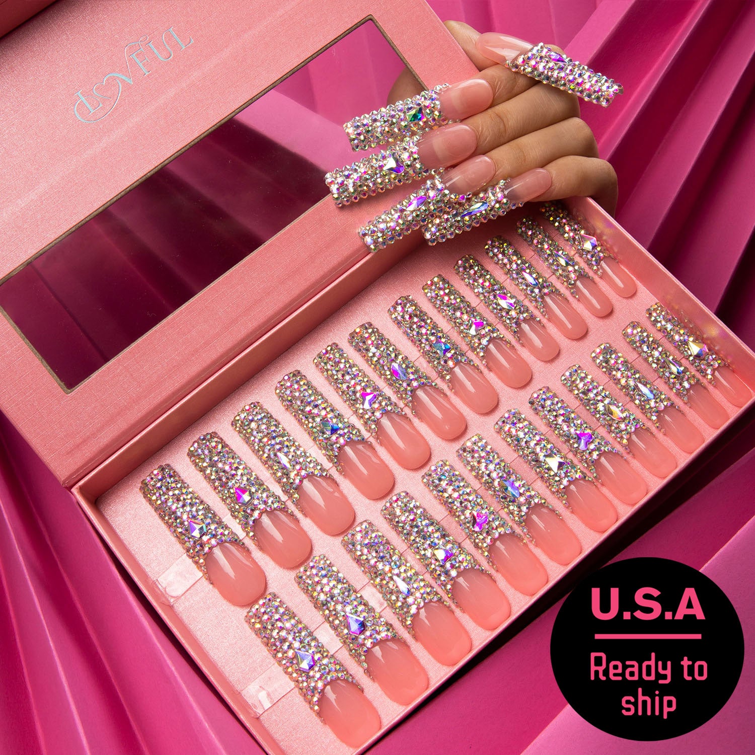 24-piece set of Angel's Tear press-on nails displayed in a pink Lovful-branded box. The nails feature a French tip design with radiant rhinestones. A hand shows some nails applied. U.S.A Ready to ship.