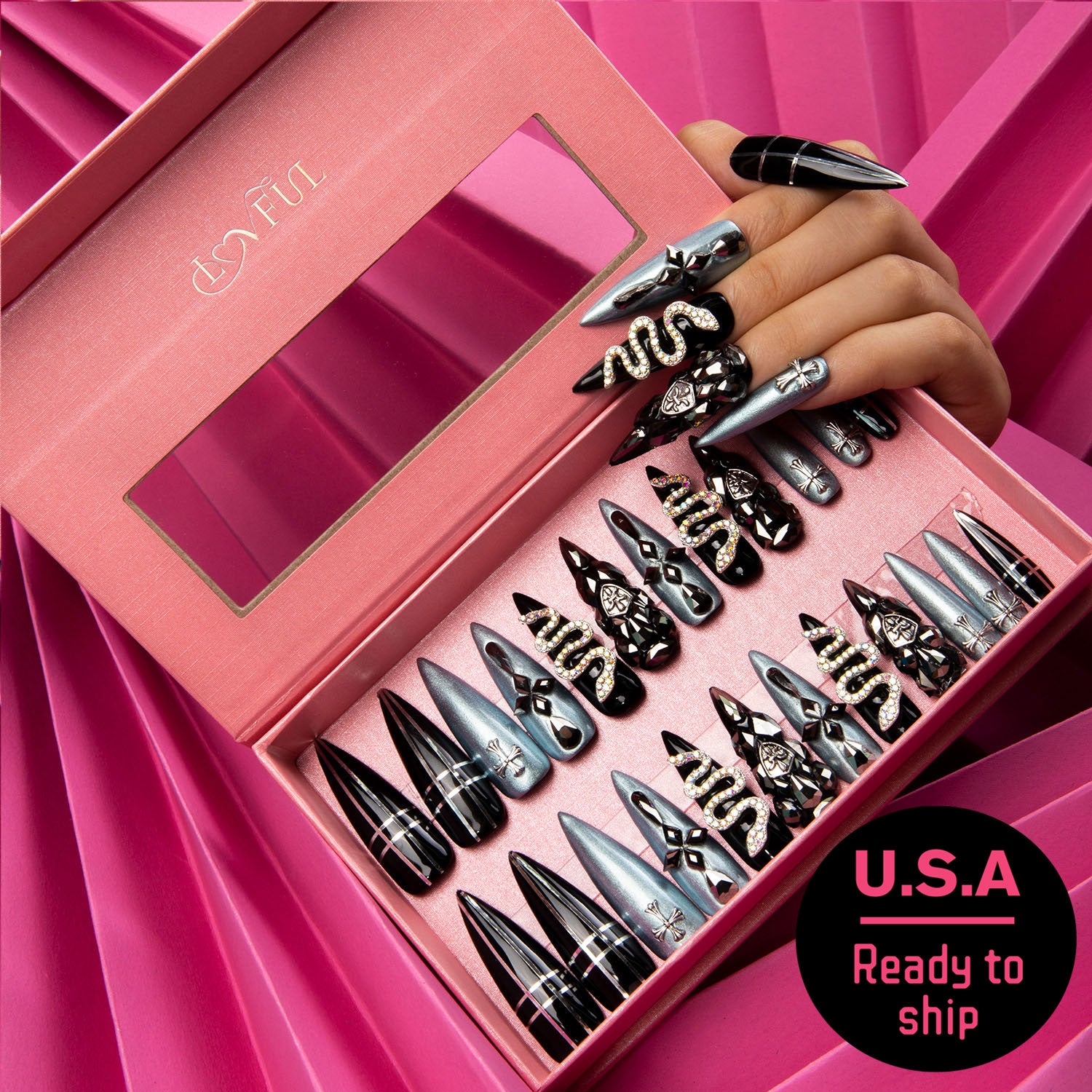 Pink box with 24 black and silver press-on nails with rhinestones and snake motifs, hand showcasing similar nails, text 'U.S.A Ready to ship'