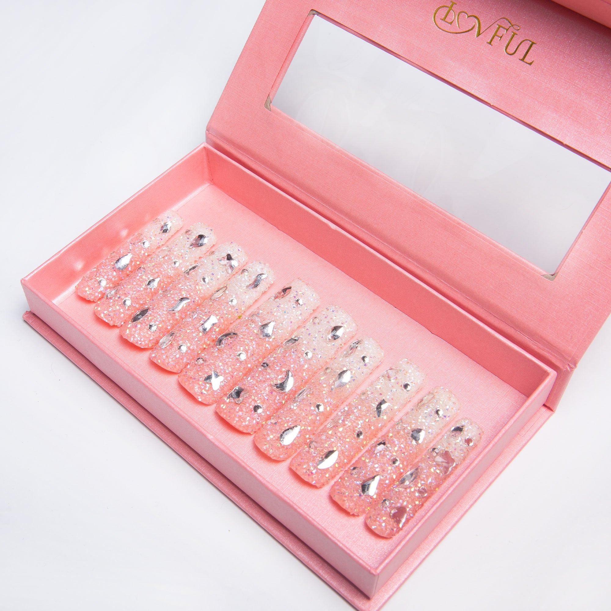 Pink rhinestone press-on nails in box