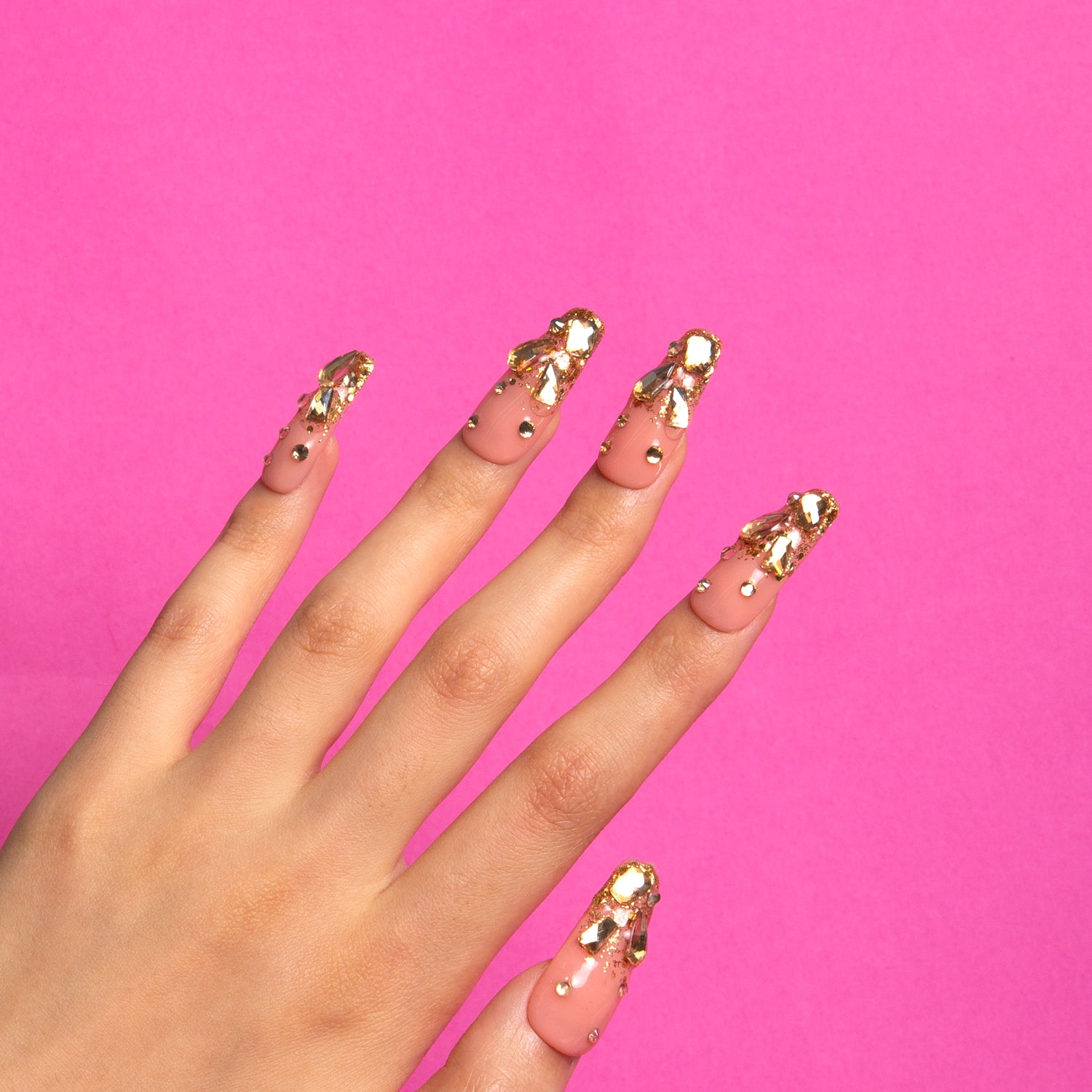 Stardust press-on nails become gilded works of art, like a sunrise over a royal residence.